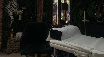 Luxurious treatment room at I D BEAUTY, Stoke-on-Trent, England, GB with elegant decor and lush greenery.