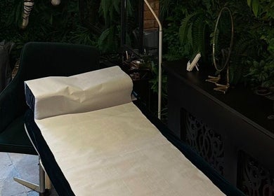 Relaxing massage bed at I D BEAUTY, Stoke-on-Trent, England, GB, surrounded by lush decor.