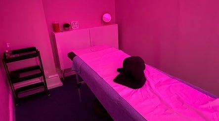 Tranquil massage room with pink lighting at Majestic Beauty, Plymouth, England, GB.