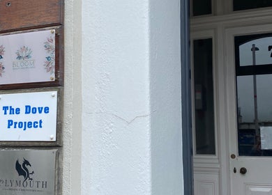 Entrance of Majestic Beauty in Plymouth, England, with elegant signage.