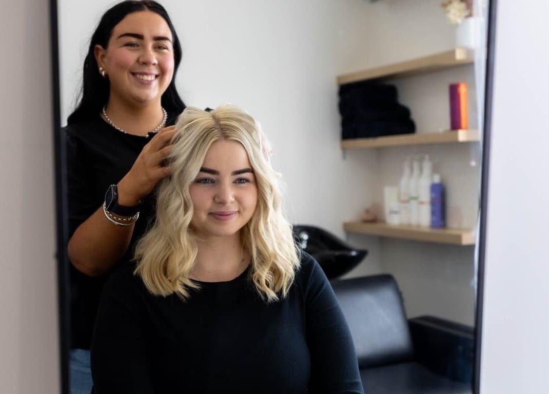 Stylist creating elegant hairstyle at The Hair Lounge, Emerald, Queensland, AU.
