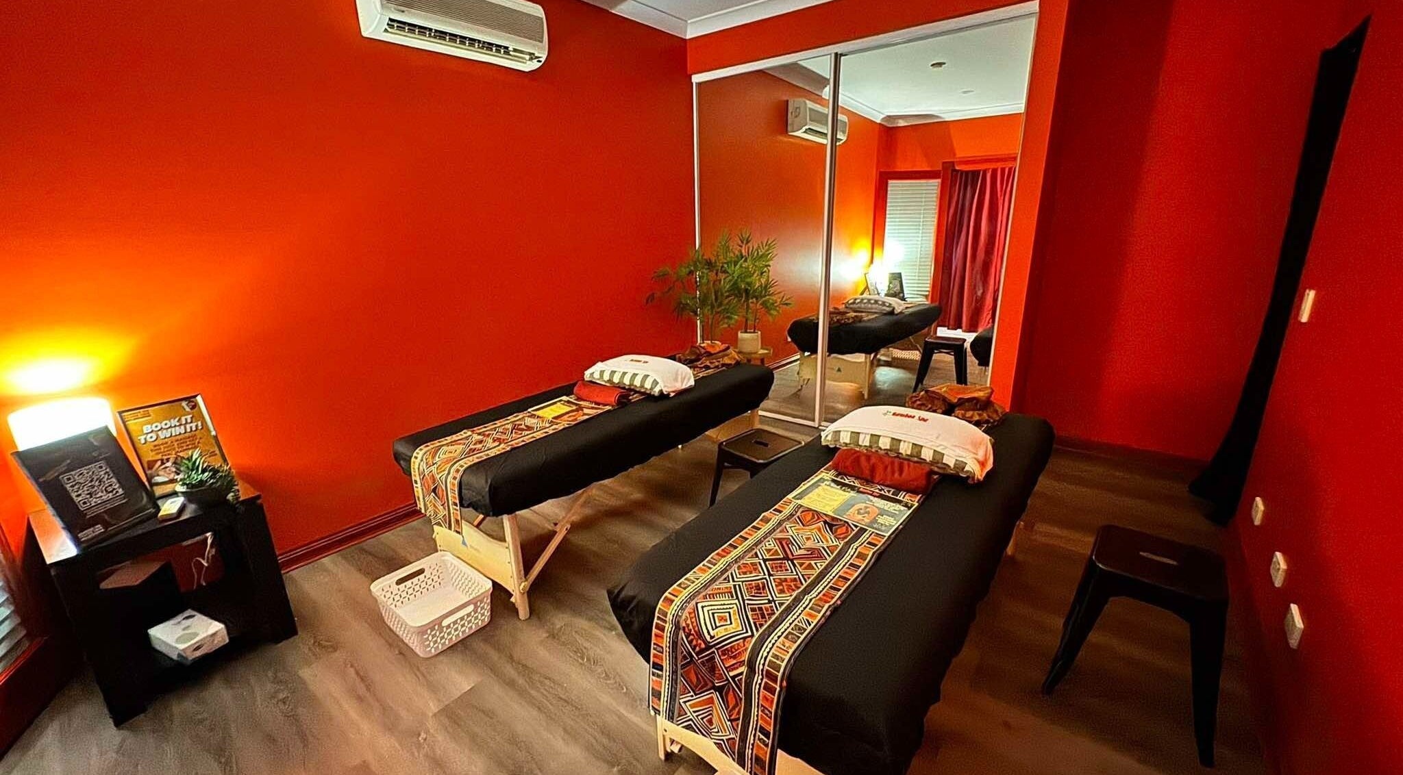 Relaxing massage room at Bamboo Spa Pascoe Vale in Melbourne, Victoria, AU, featuring vibrant decor and twin tables.