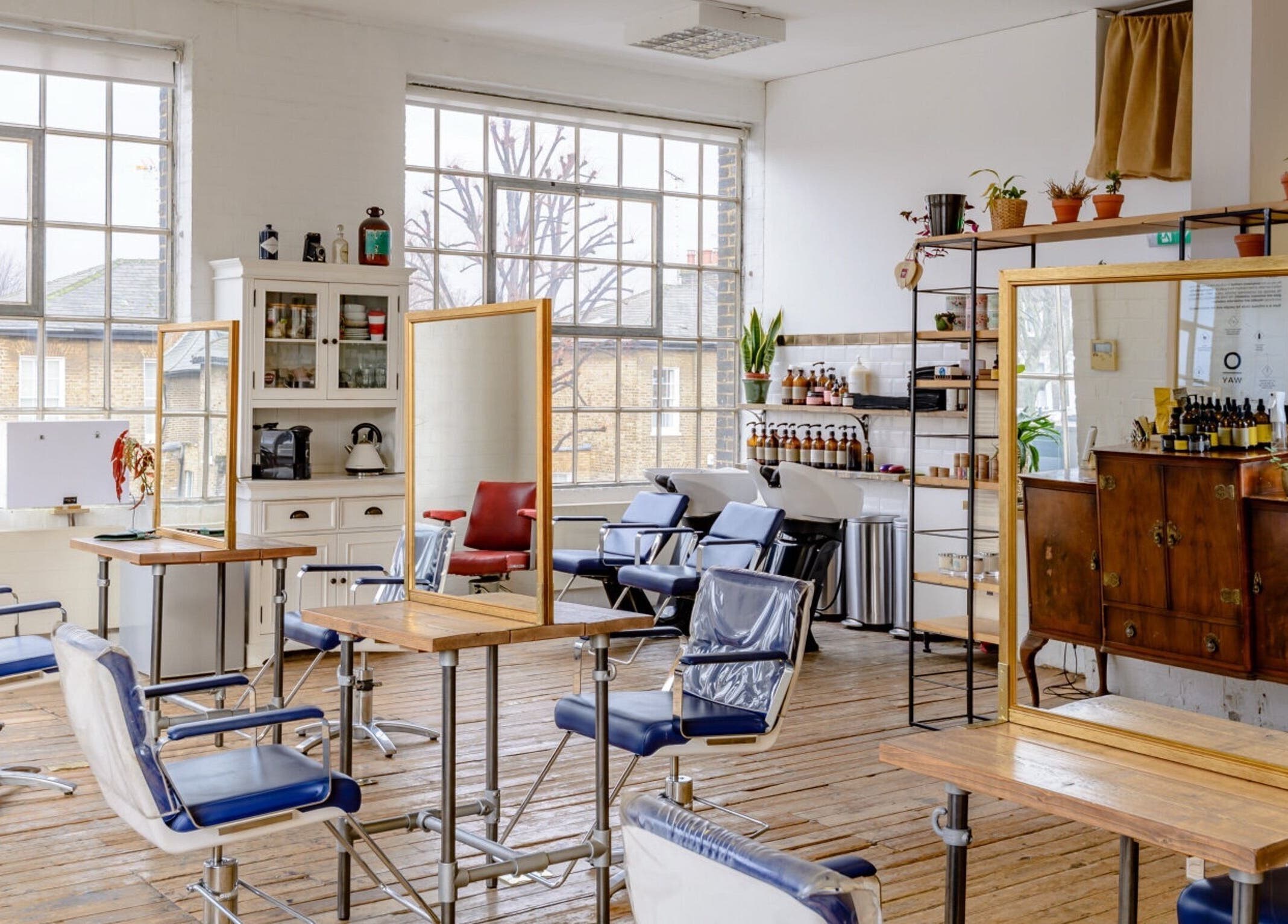 Bright and stylish interior of Ricky Alexander Hair in London, GB, featuring elegant salon chairs and mirrors.