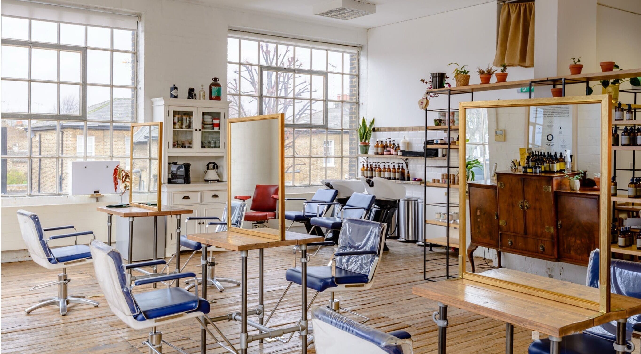 Bright and stylish interior of Ricky Alexander Hair in London, GB, featuring elegant salon chairs and mirrors.