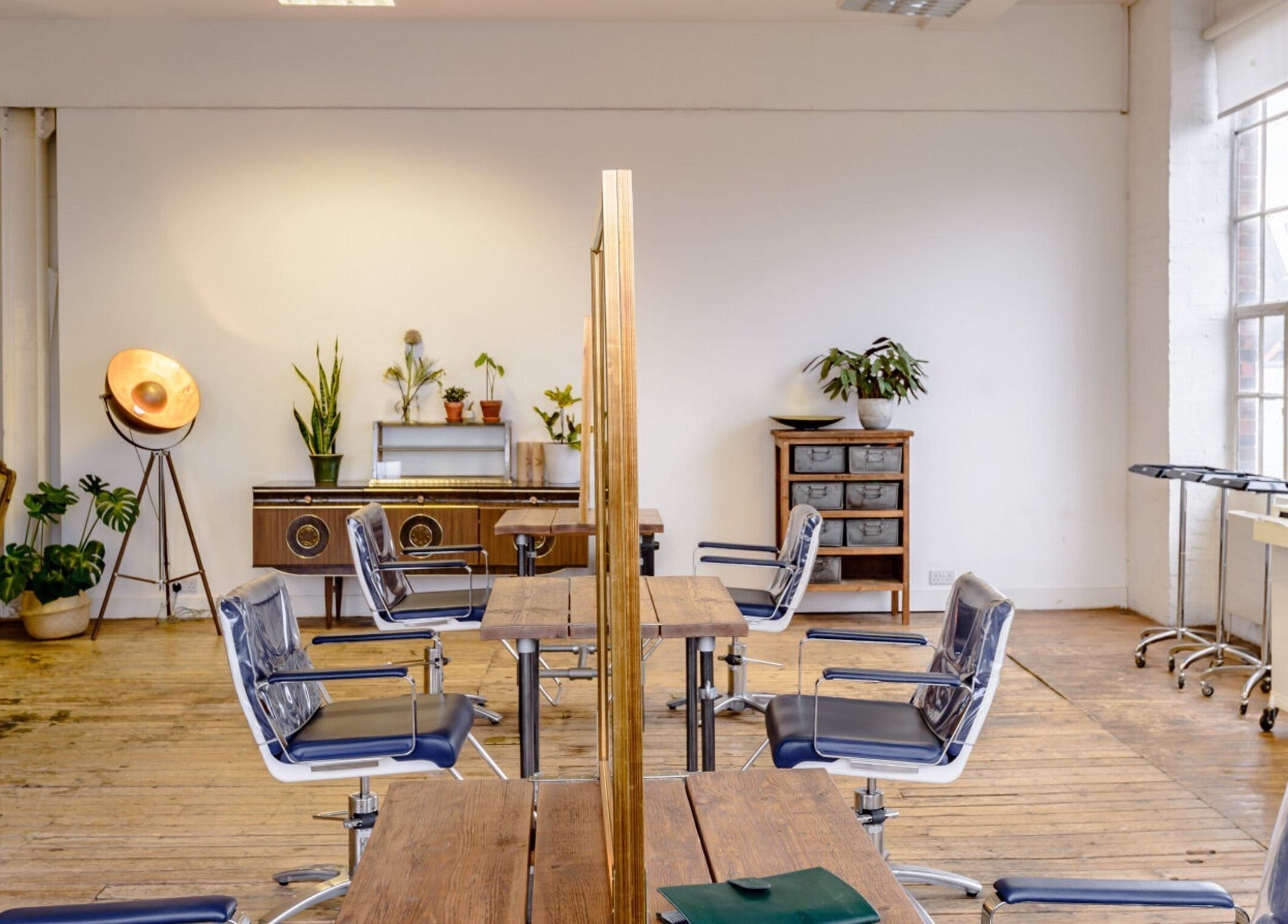 Elegant interior of Ricky Alexander Hair in London, GB with stylish decor and modern chairs.