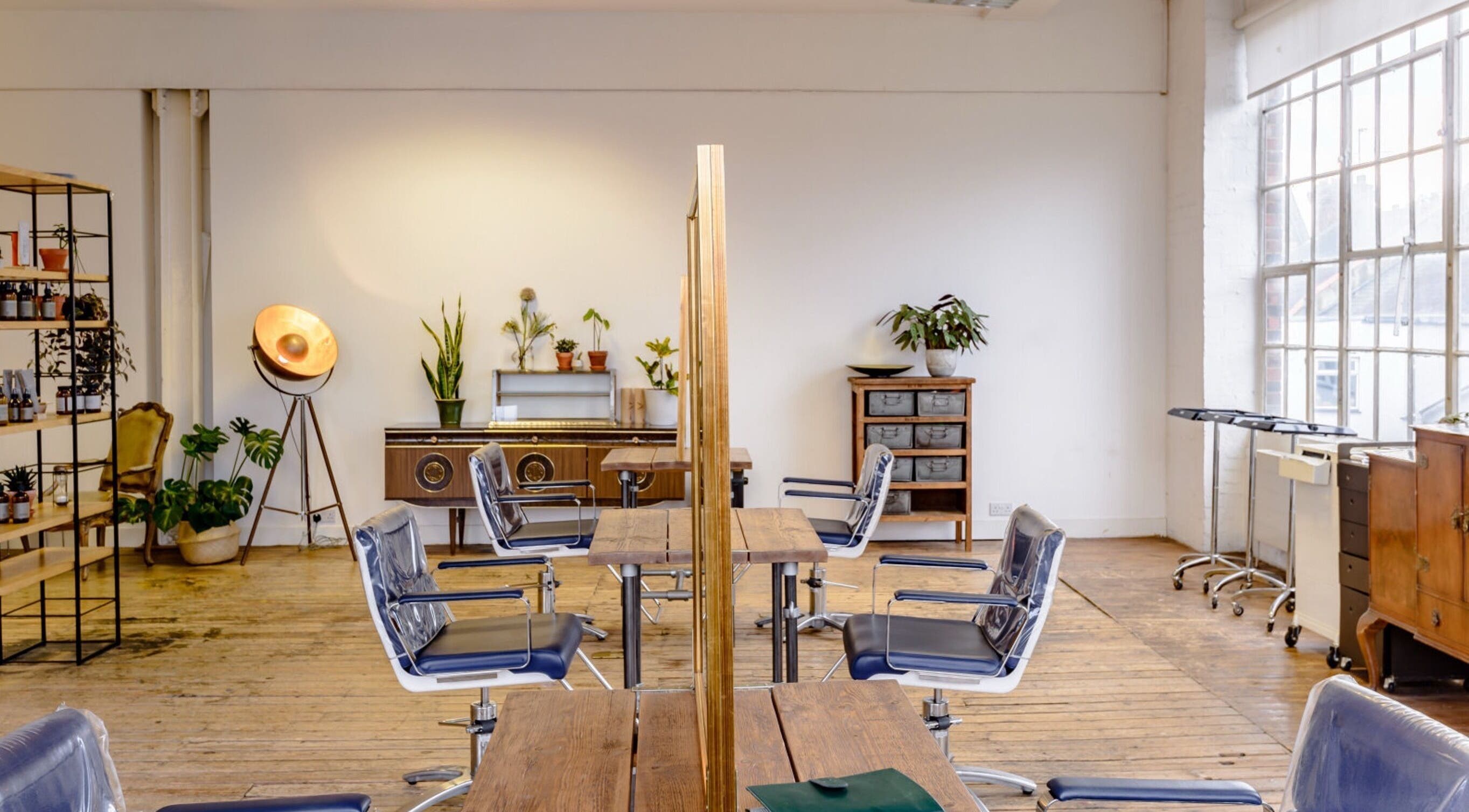 Elegant interior of Ricky Alexander Hair in London, GB with stylish decor and modern chairs.