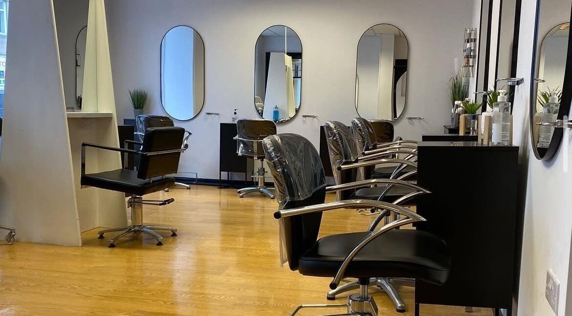 Modern salon chairs and mirrors at The Hair Designers, Haltwhistle, England, GB.