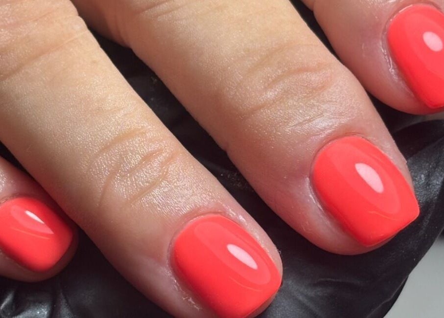Vibrant coral nails manicured at LTbeauty, Newton Abbot, England, GB, showcasing expert nail artistry.