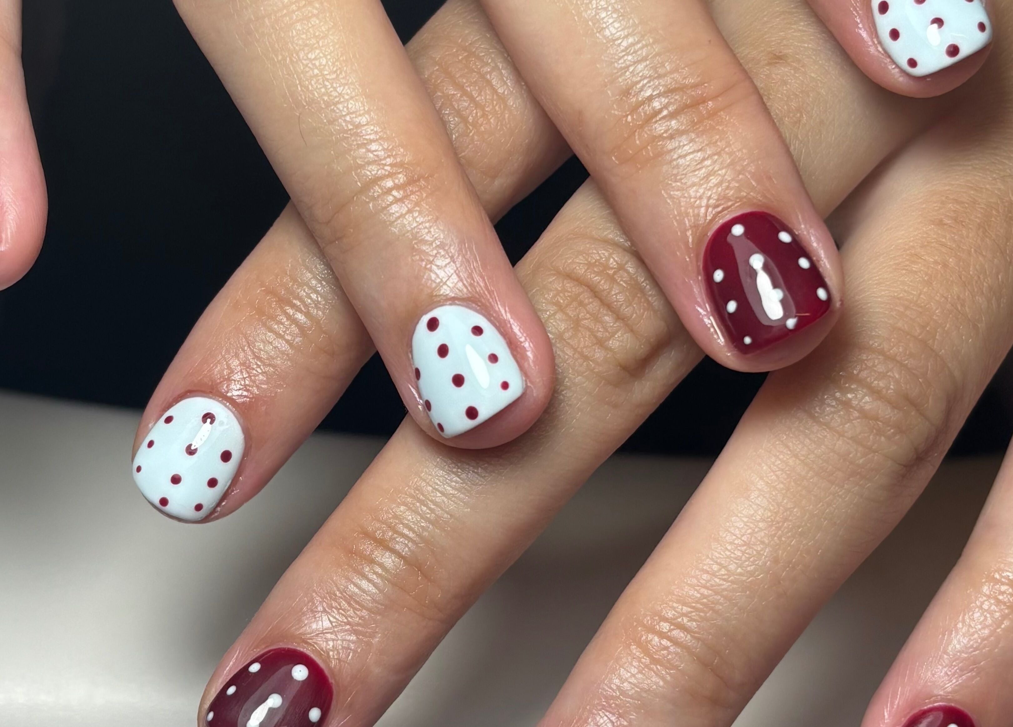 Red and white polka-dotted nails at LTbeauty, Newton Abbot, England, GB.