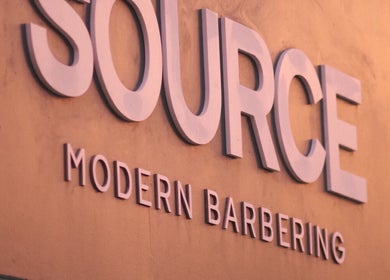 Source Barbers shop sign in Aberdeen, Scotland, GB, highlighting modern barbering services.