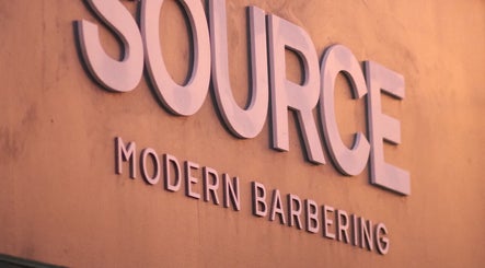 Source Barbers shop sign in Aberdeen, Scotland, GB, highlighting modern barbering services.