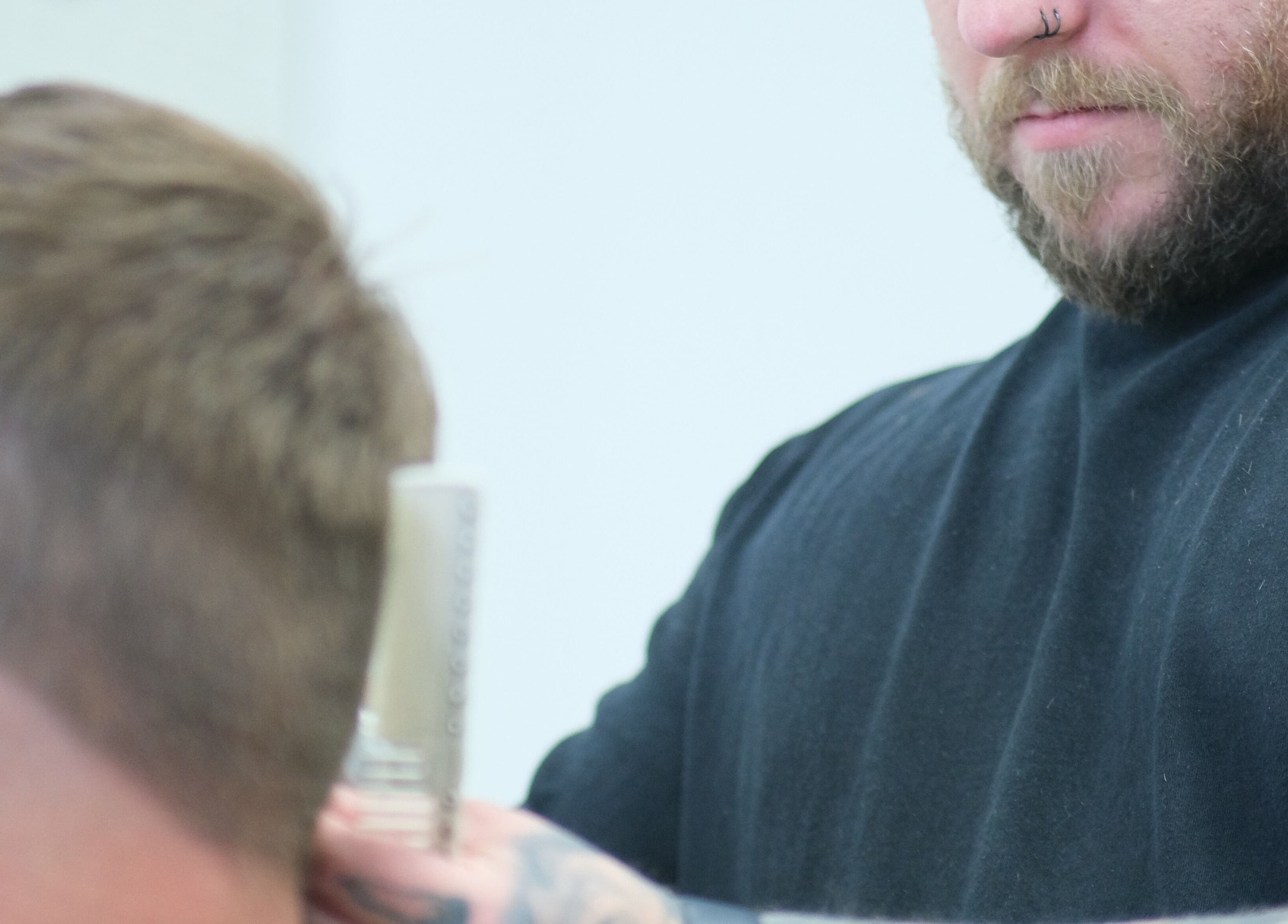 Barber at Source Barbers, Aberdeen, Scotland, GB crafting precise haircut.