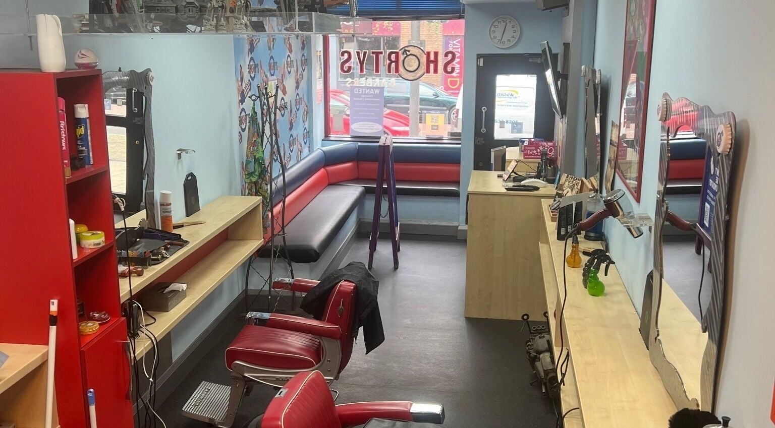 Interior of Shortys - Hinckley, a vibrant salon in Hinckley, England, GB with red chairs and modern decor.