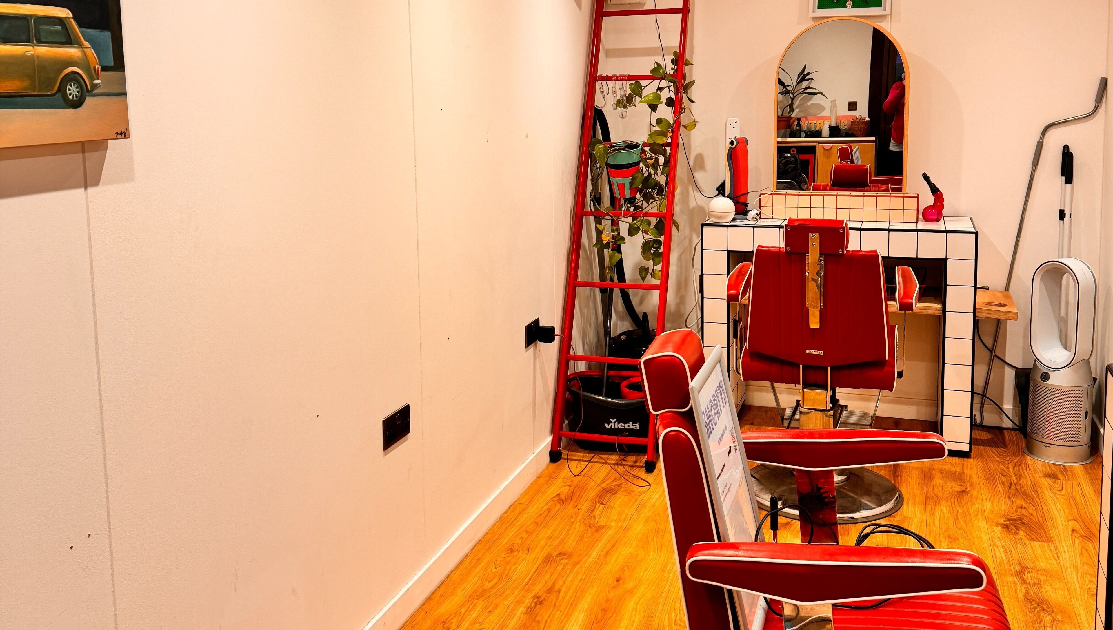 Chic retro hair salon interior at Shortys - Leicester, featuring red chairs and stylish decor in Leicester, England, GB.