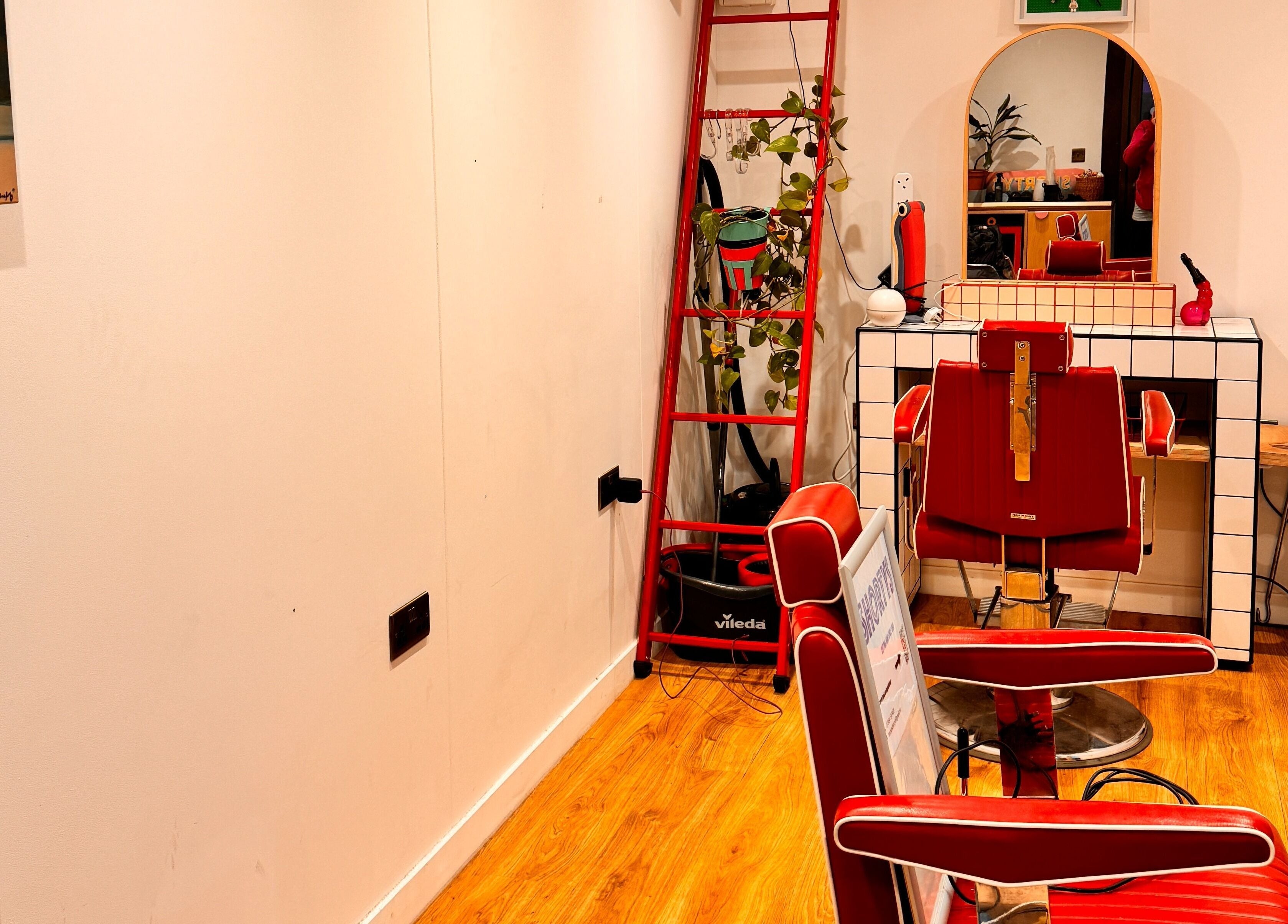 Chic retro hair salon interior at Shortys - Leicester, featuring red chairs and stylish decor in Leicester, England, GB.