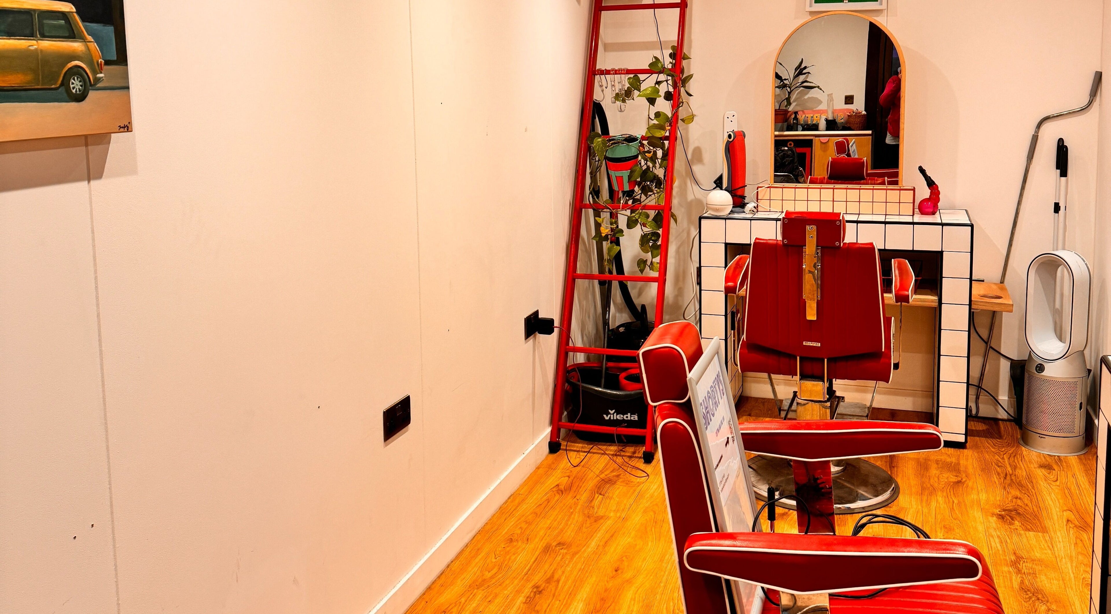 Chic retro hair salon interior at Shortys - Leicester, featuring red chairs and stylish decor in Leicester, England, GB.