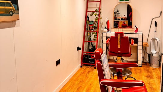Chic retro hair salon interior at Shortys - Leicester, featuring red chairs and stylish decor in Leicester, England, GB.