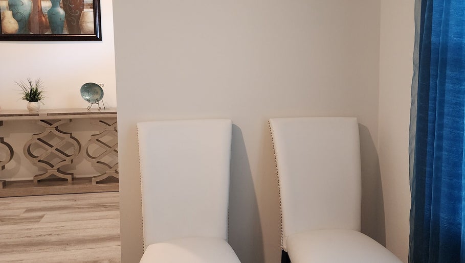 Elegant chairs in Scalp & Strand Wellness Studio, Columbia, South Carolina, creating a calming reception area.