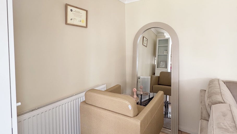 Elegant waiting area at Hair Extensions by Anarika in Hounslow, England, GB, featuring a comfy beige sofa and decor.