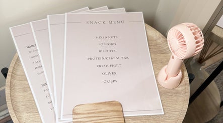 Snack menu and table fan at Hair Extensions by Anarika in Hounslow, England, GB.