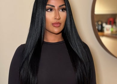 Model with sleek, black hair extensions at Hair Extensions by Anarika, Hounslow, England, GB.