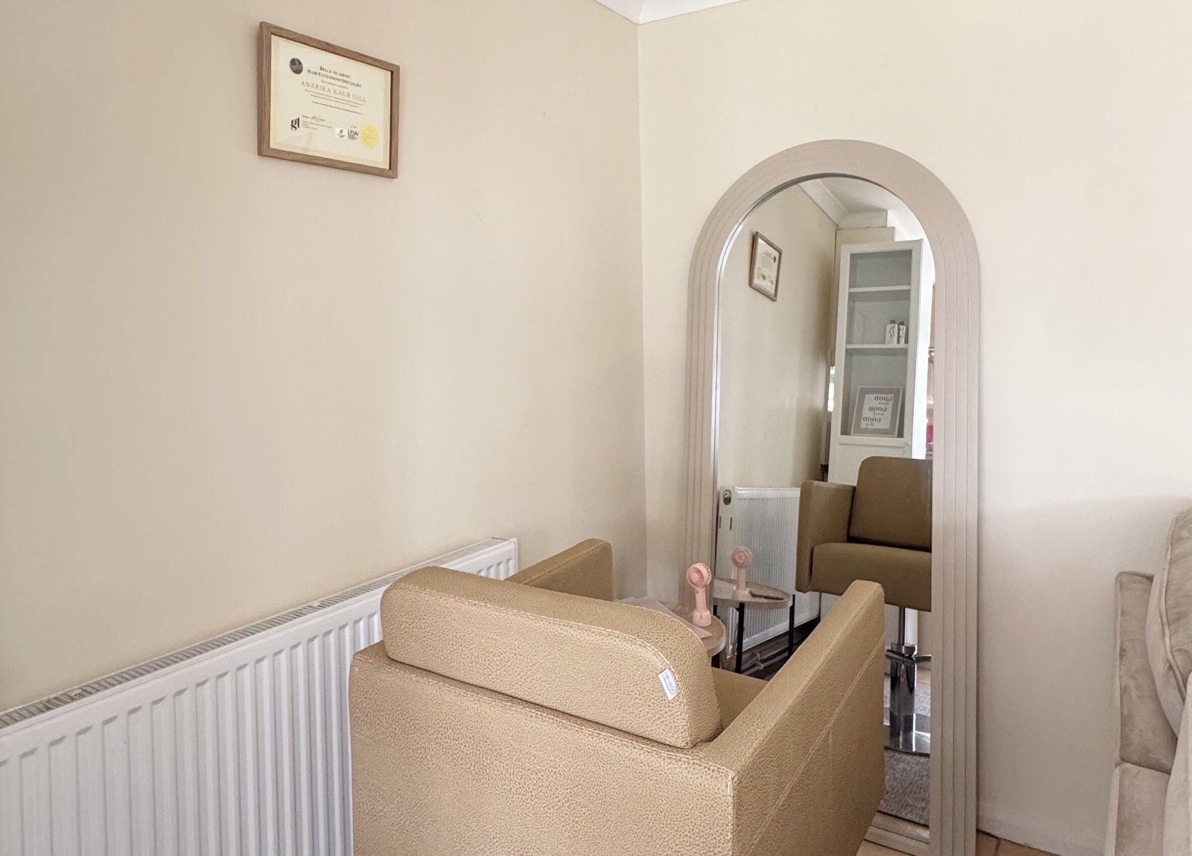 Cozy salon corner at Hair Extensions by Anarika, featuring a stylish chair and mirror in Hounslow, England, GB.