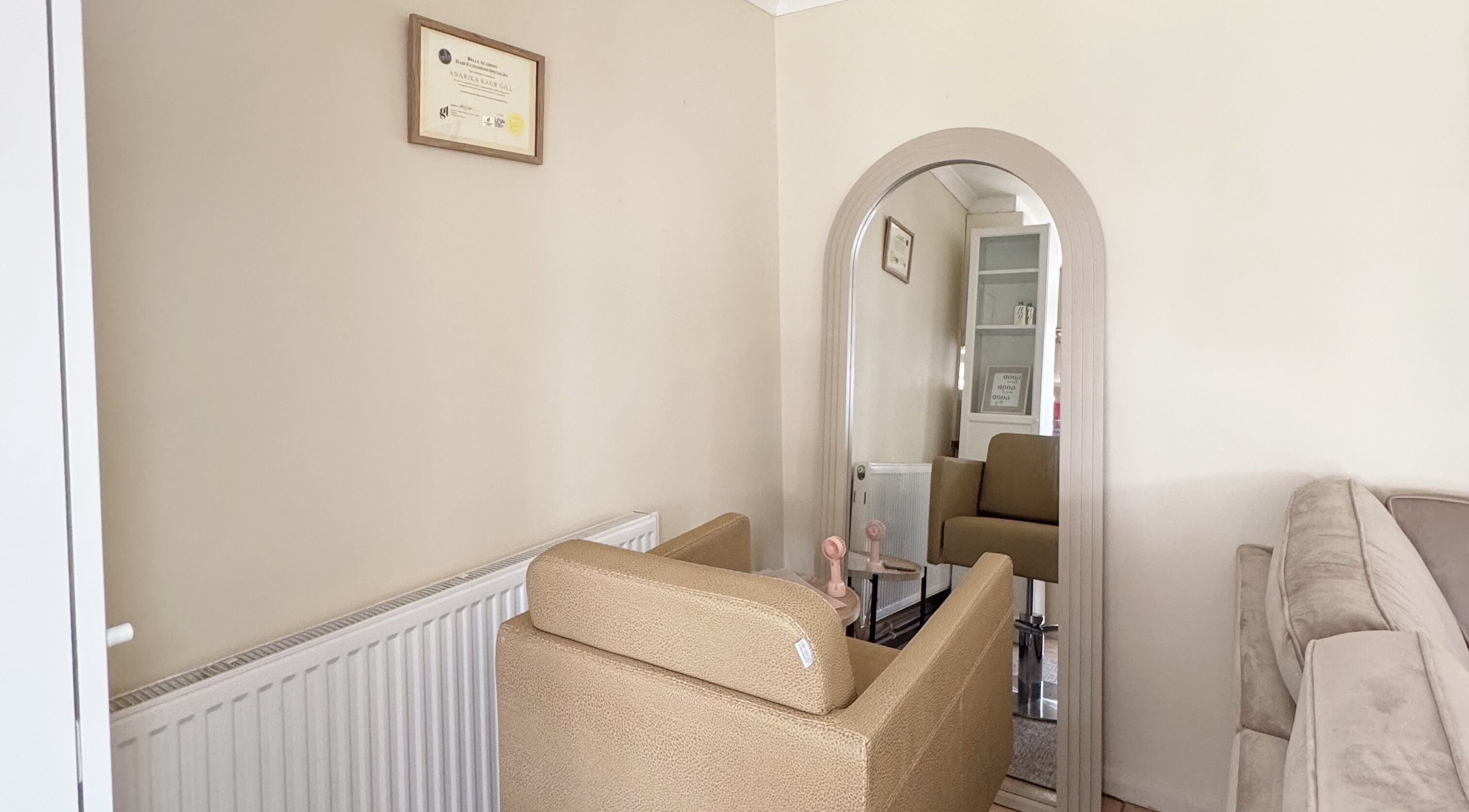 Cozy salon corner at Hair Extensions by Anarika, featuring a stylish chair and mirror in Hounslow, England, GB.