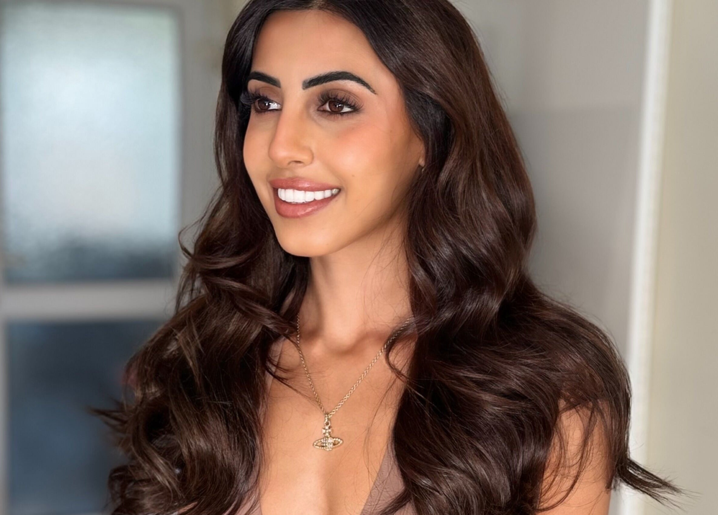 Woman with elegant brunette waves at Hair Extensions by Anarika, Hounslow, England, GB.