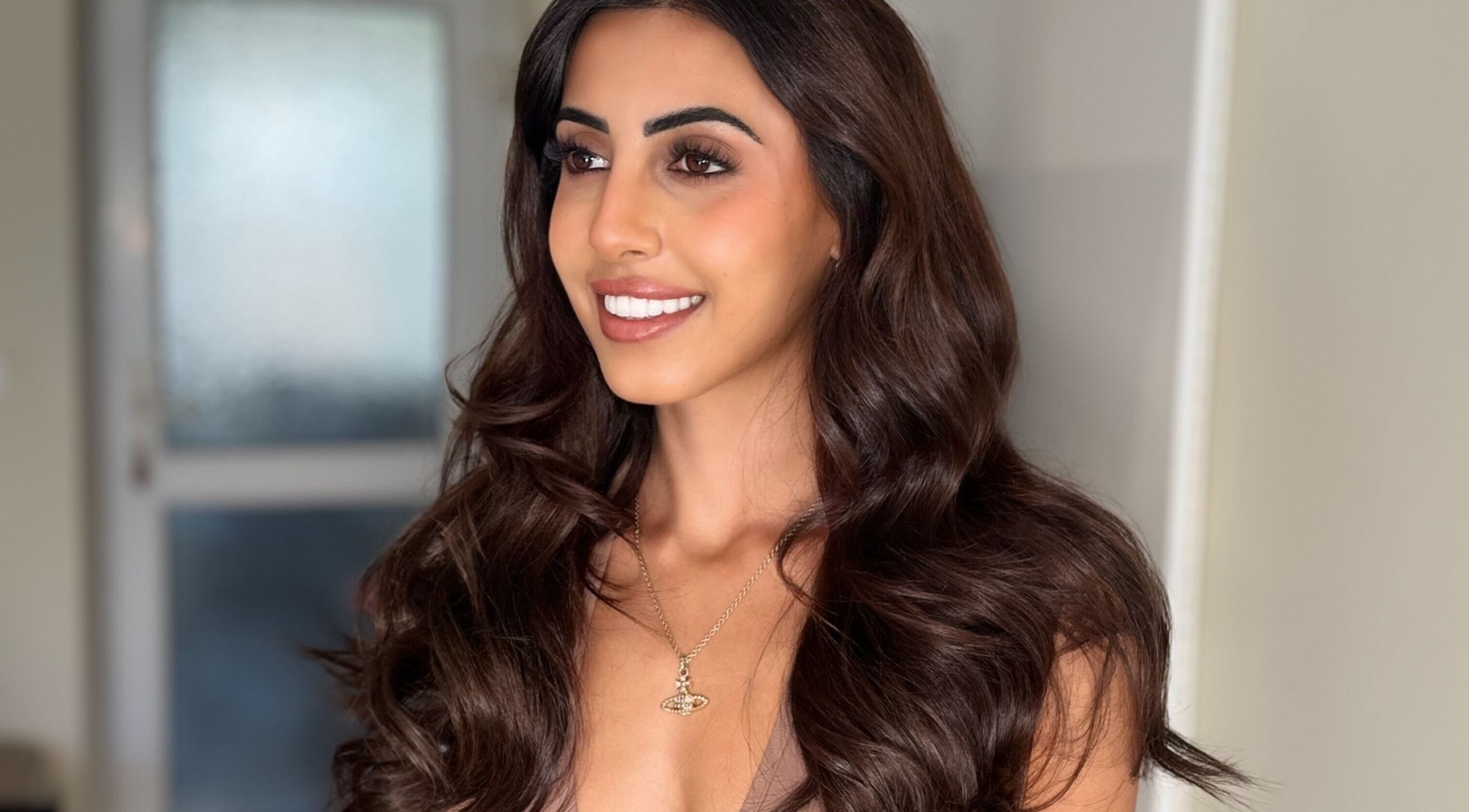 Woman with elegant brunette waves at Hair Extensions by Anarika, Hounslow, England, GB.