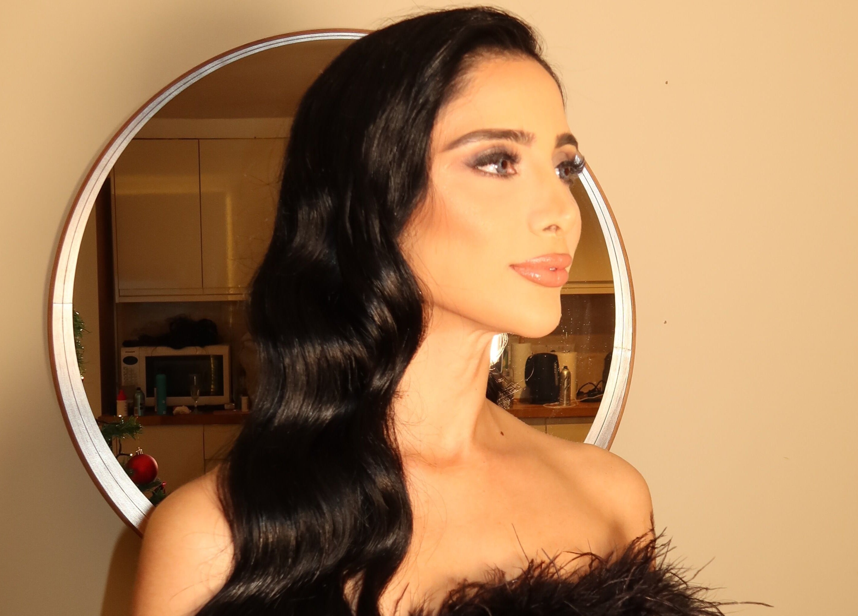 Elegant woman with flowing hair in a mirror at Hair Extensions by Anarika, Hounslow, England, GB.