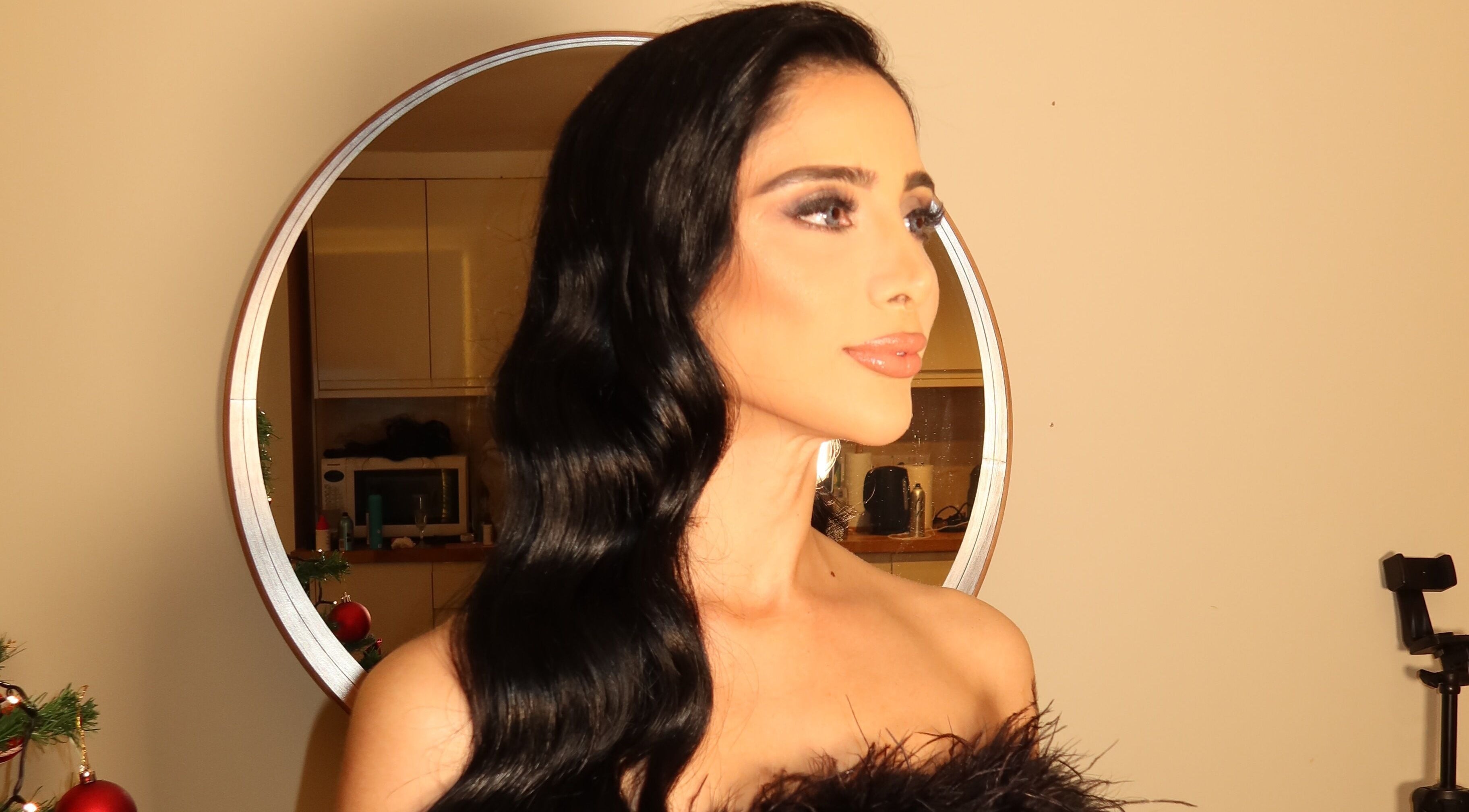 Elegant woman with flowing hair in a mirror at Hair Extensions by Anarika, Hounslow, England, GB.