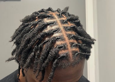 Textured braids styled at EVSTYLES, London, England, GB. Showcases intricate detailing.