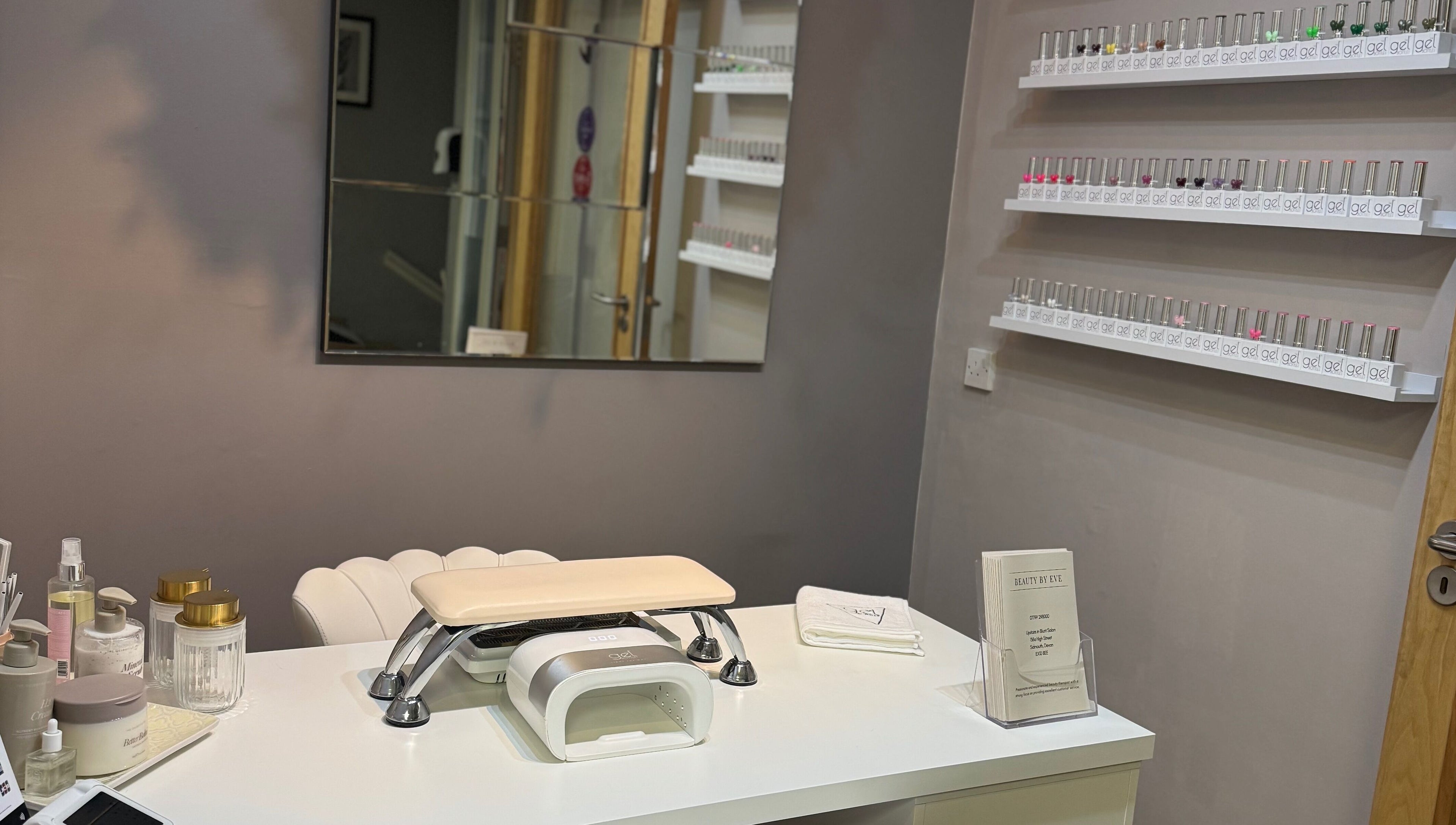 Nail station at BeautyByEve in Sidmouth, England, GB with neatly arranged nail polishes and tools.