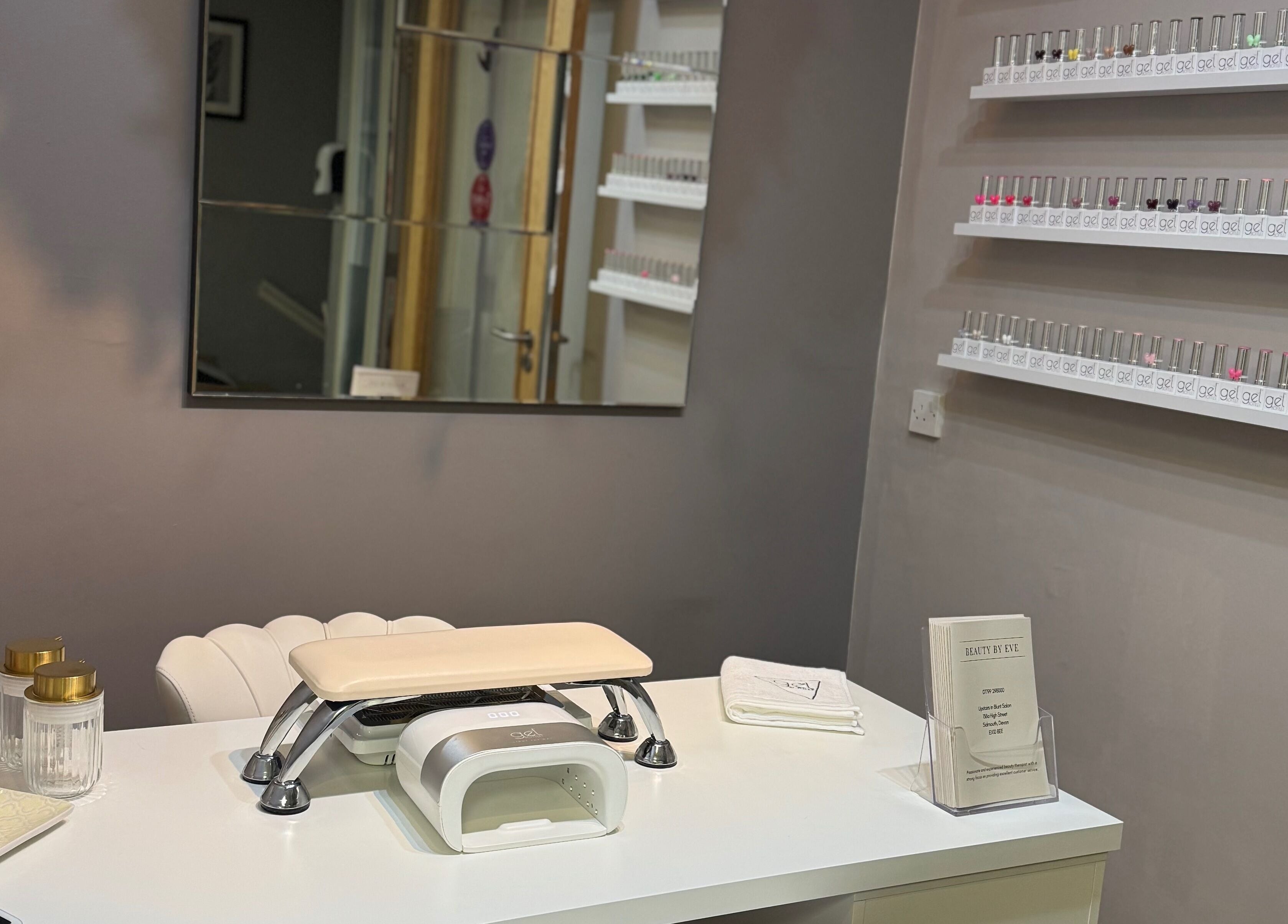 Nail station at BeautyByEve in Sidmouth, England, GB with neatly arranged nail polishes and tools.