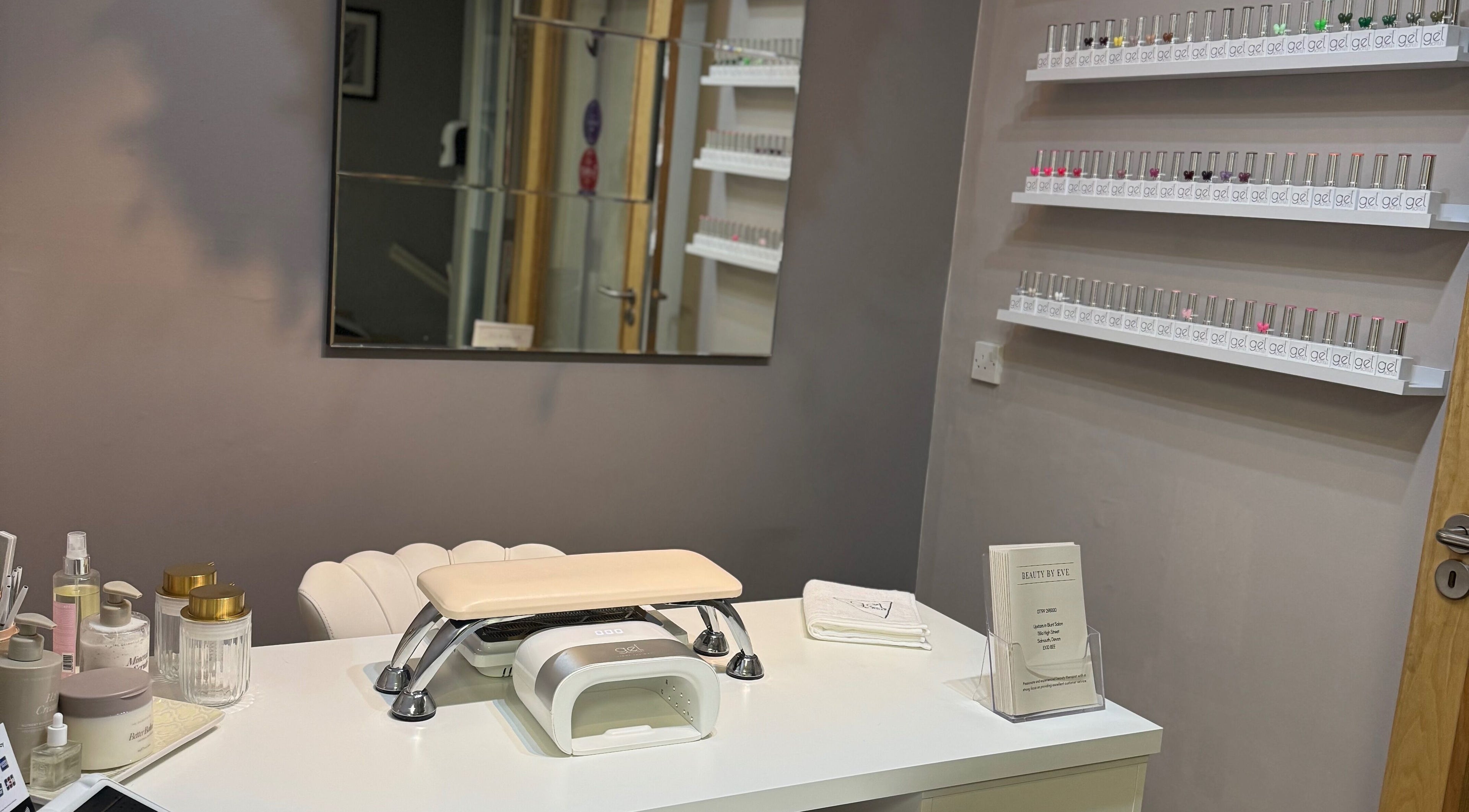 Nail station at BeautyByEve in Sidmouth, England, GB with neatly arranged nail polishes and tools.