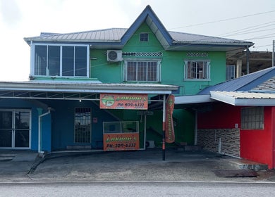 The Reset Bar’s vibrant, colorful facade in Sangre Grande, TT showcasing its inviting exterior design.