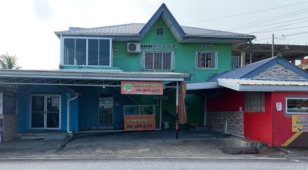 The Reset Bar’s vibrant, colorful facade in Sangre Grande, TT showcasing its inviting exterior design.