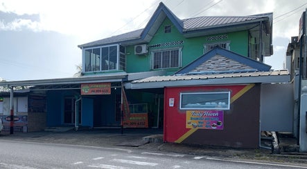 Front view of The Reset bar at Sangre Grande, TT, highlighting the venue's distinctive architecture.