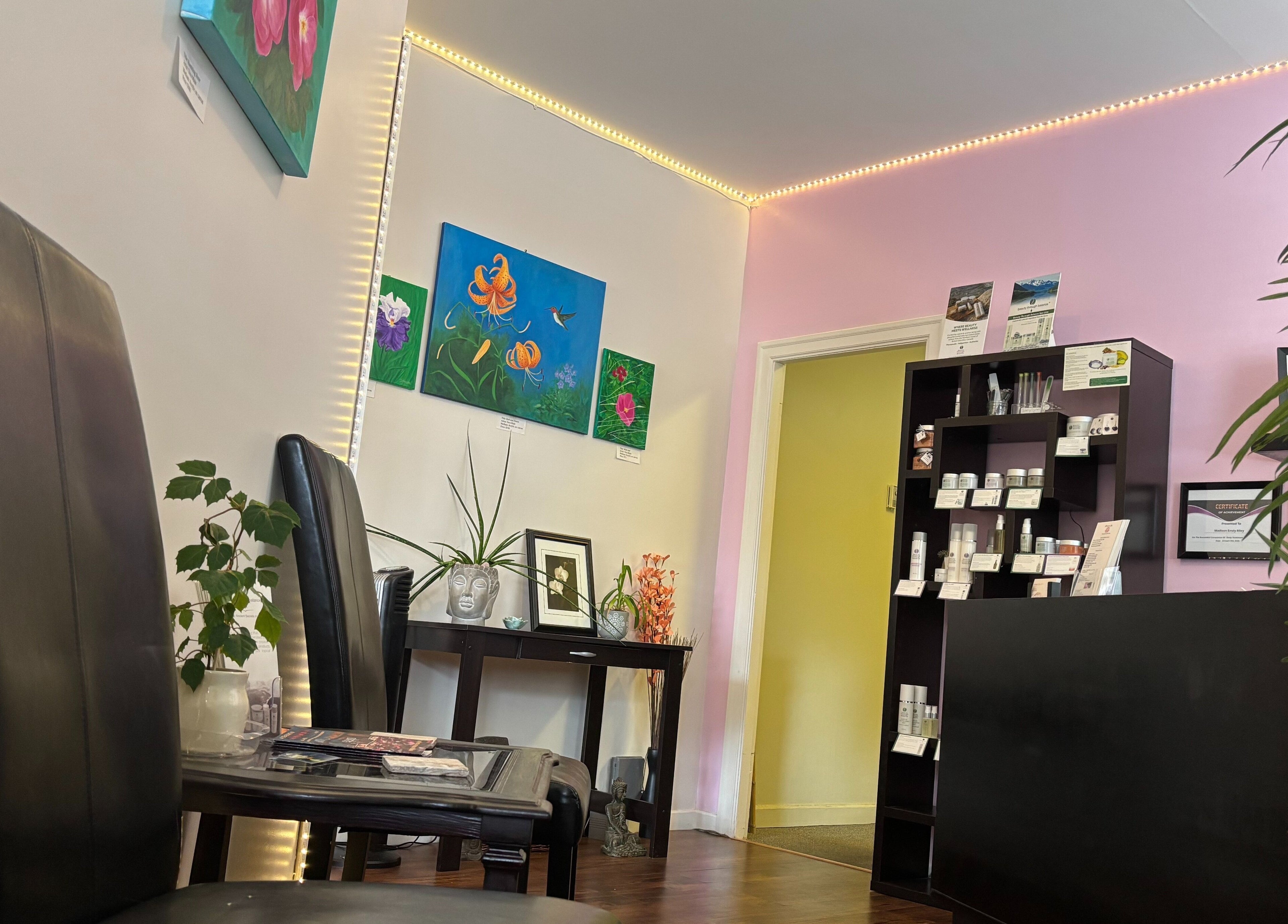 Elegant reception area at Essensia Spa, Salmo, British Columbia, CA, with artwork and product displays.