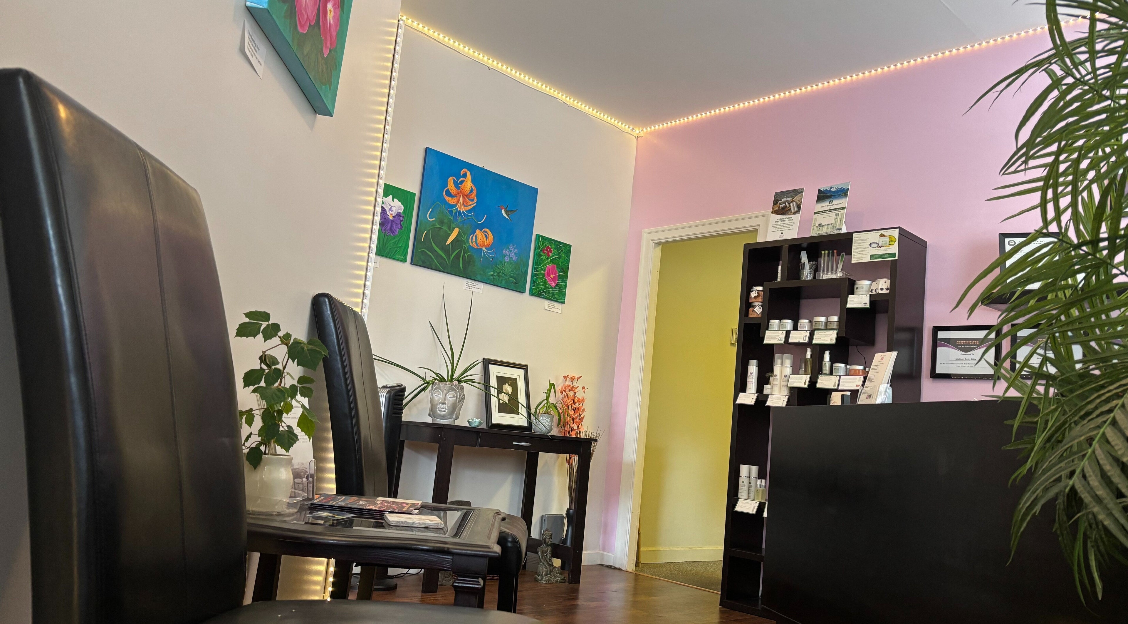 Elegant reception area at Essensia Spa, Salmo, British Columbia, CA, with artwork and product displays.