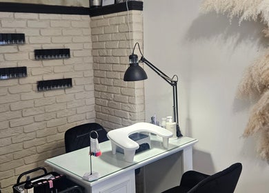 Modern nail station at Shaped by Shannon, Stafford, England, GB with chic decor and white brick wall.