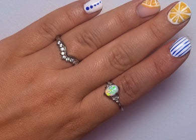 Vibrant nail art design at Shaped by Shannon, Stafford, England, GB, showcasing creative patterns and rings.