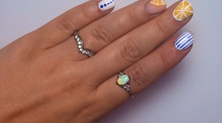 Vibrant nail art design at Shaped by Shannon, Stafford, England, GB, showcasing creative patterns and rings.