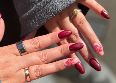 Beautiful red manicure with floral design at Shaped by Shannon, Stafford, England, GB.