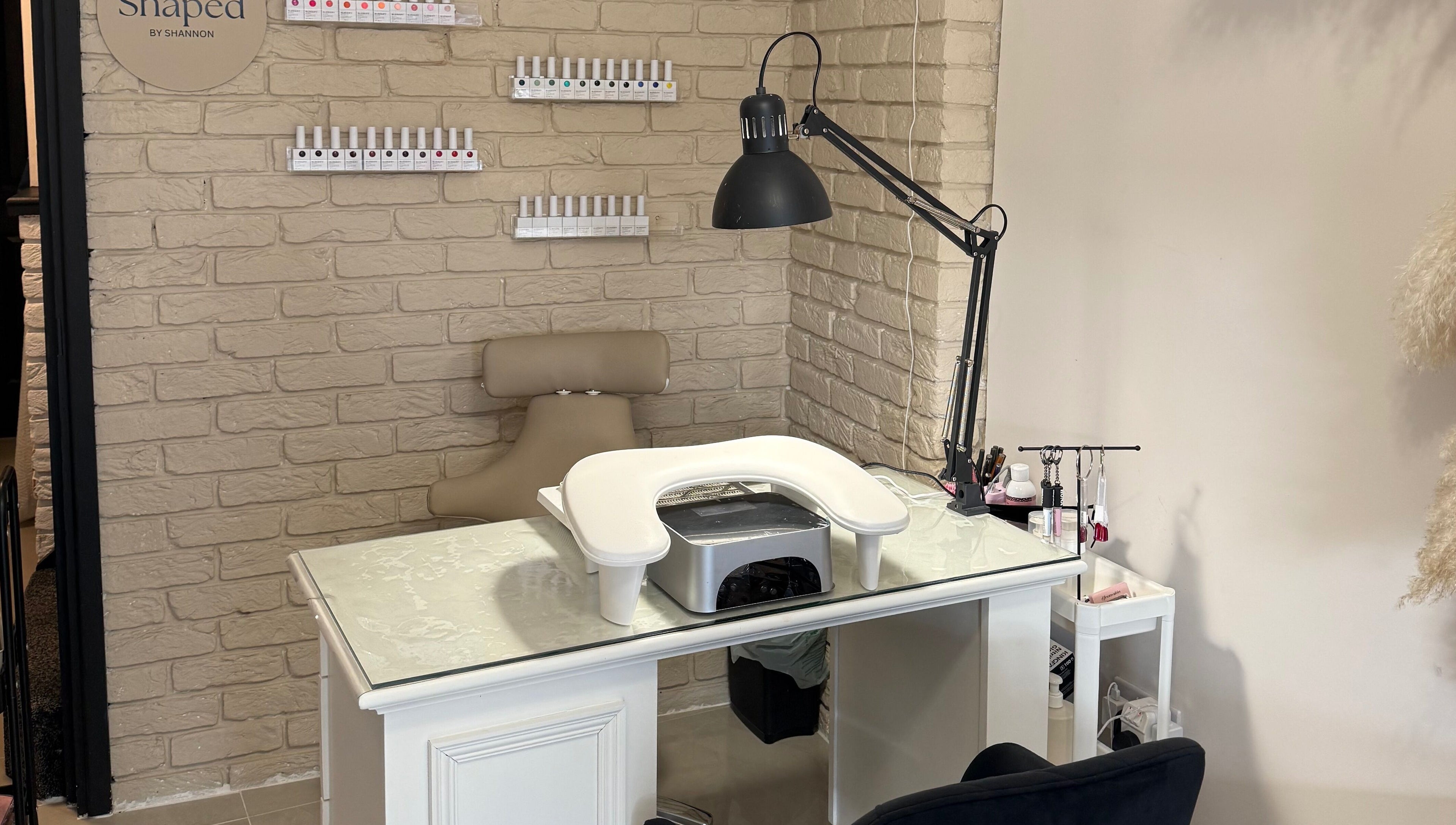 Nail station at Shaped by Shannon in Stafford, England, GB, featuring chic decor and manicure tools.