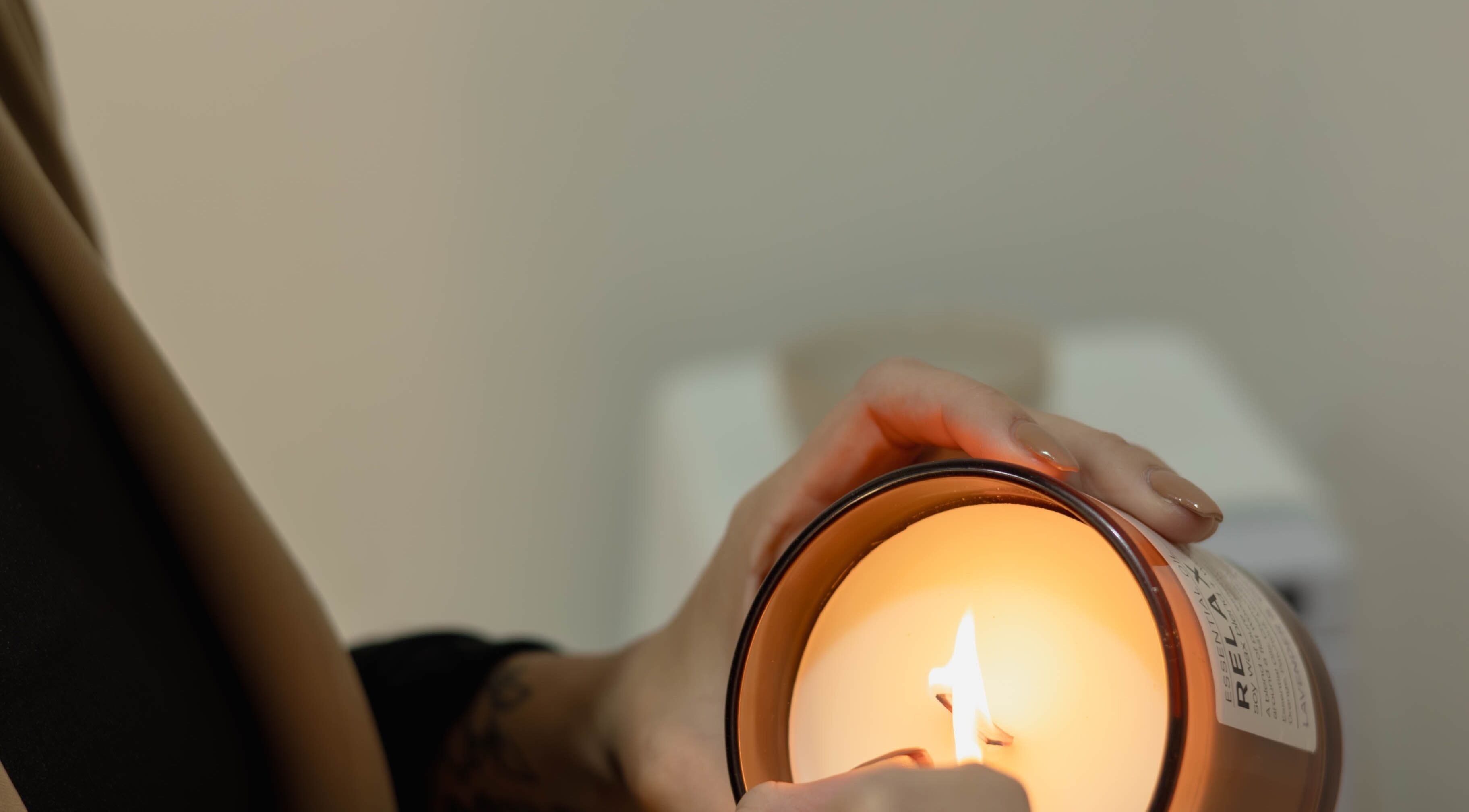 Warm candle being lit at Omorphia Beauty in Budgewoi, New South Wales, AU for a serene ambiance.