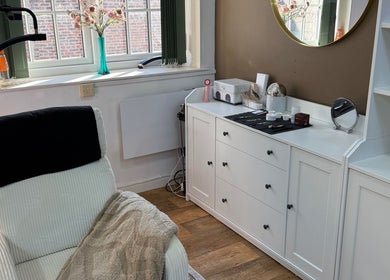 Relaxing treatment room at Beauty by Brydie, Thirsk, England, GB featuring a cozy chair and elegant decor.