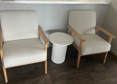 Inviting seating area with two cream chairs at Sykes Sports Massage Therapy, Auckland, Auckland, NZ.