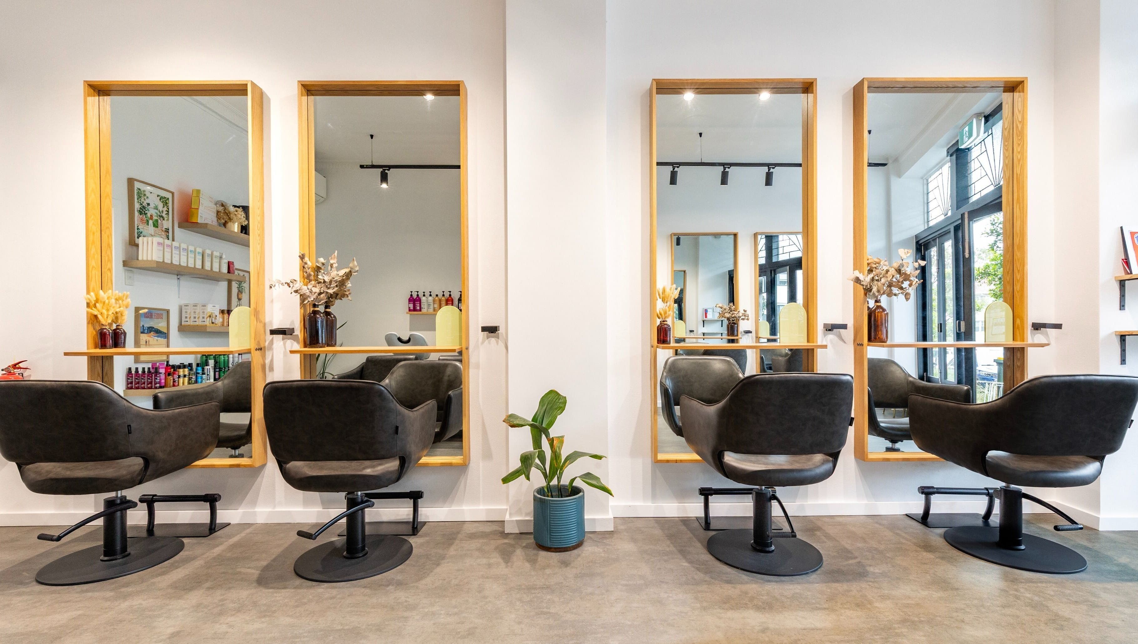 Elegant salon chairs and mirrors at Collective and Co Coogee, Coogee, New South Wales, AU, creating a stylish atmosphere.