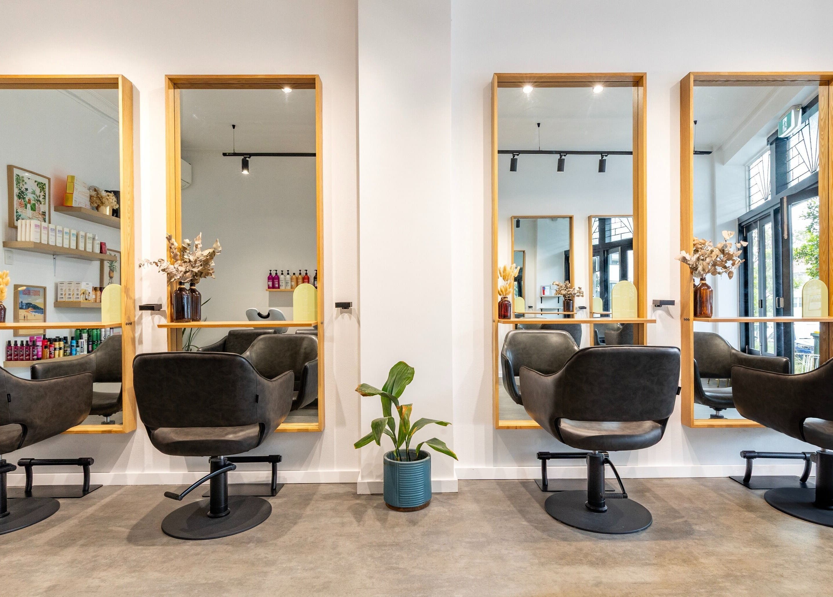 Elegant salon chairs and mirrors at Collective and Co Coogee, Coogee, New South Wales, AU, creating a stylish atmosphere.